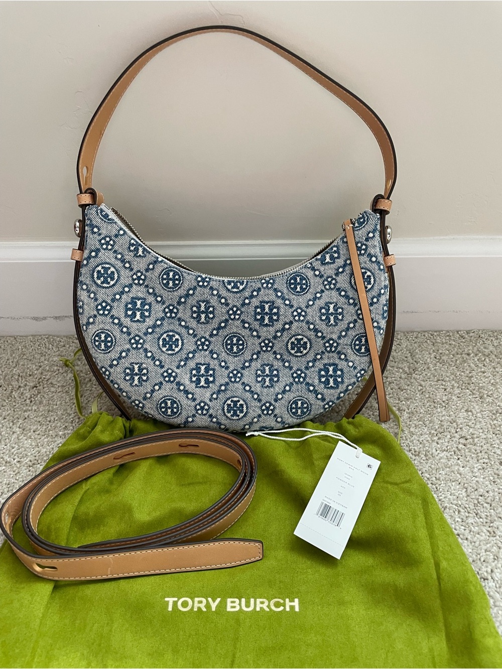 Tory Burch Romy Denim Half Moon Shoulder Bag with ith crossbody strap